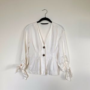 White button blouse with tied sleeves.
